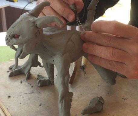 working progress of the creature modeled in clay